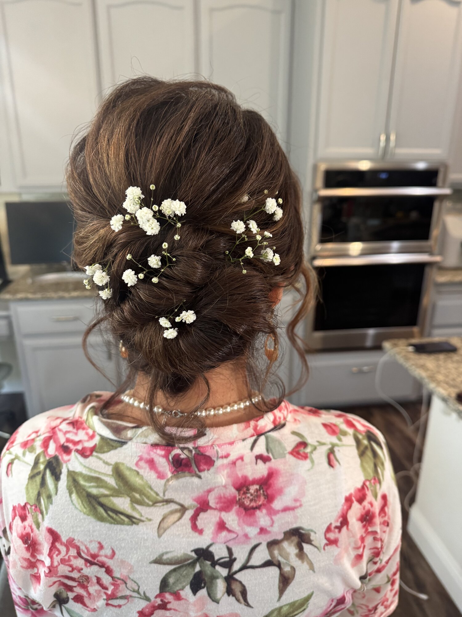 Low bridal updo dressed with baby's breath